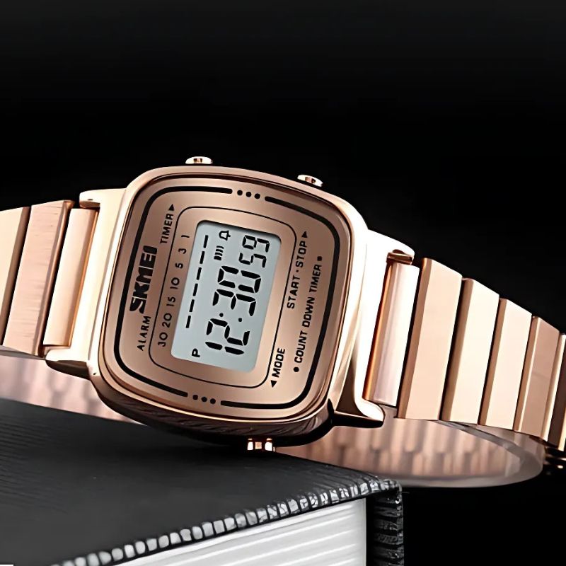 Montre Digitale Femme Design Or Rose et Lecture Instantanée posée sur un livre