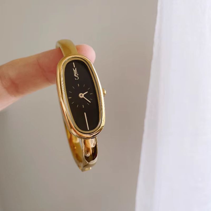 Montre Femme Jonc Doré Cadran Noir Ovale Résistante à l’Eau  Image