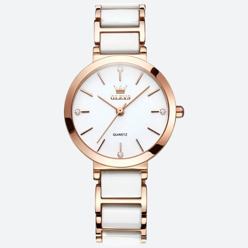 Montre Vintage pour Femme de forme ronde or rose et blanche, cadran blanc minimaliste orné de cristaux et boîtier or rose poli.