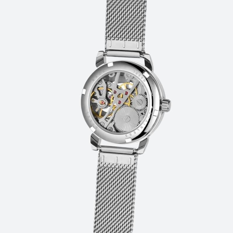 Montre Automatique Femme Bracelet Acier Maille & Cadran Ajouré en argenté vue de derrière avec le mécanisme apparent